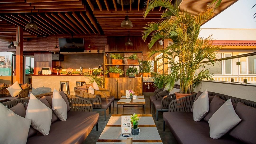 7th-floor rooftop terrace with panoramic Himalayan valley views